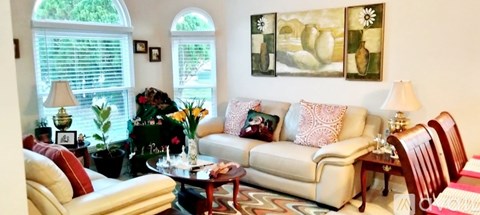 A living room with a white couch and a coffee table.