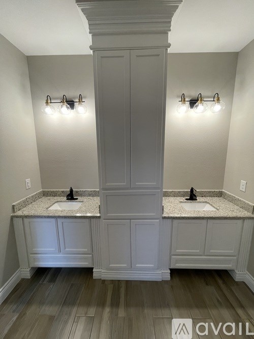 A bathroom with a sink and a cabinet.