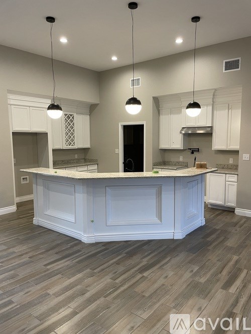A kitchen with a large island in the middle.