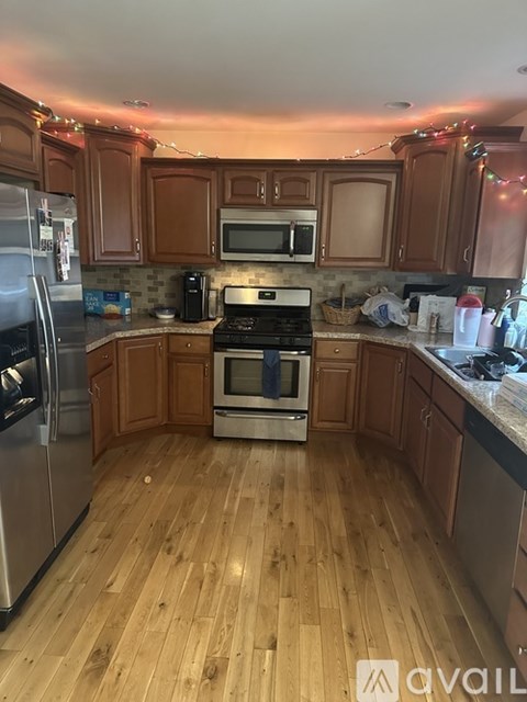 A kitchen with wooden floors and a stove top oven.