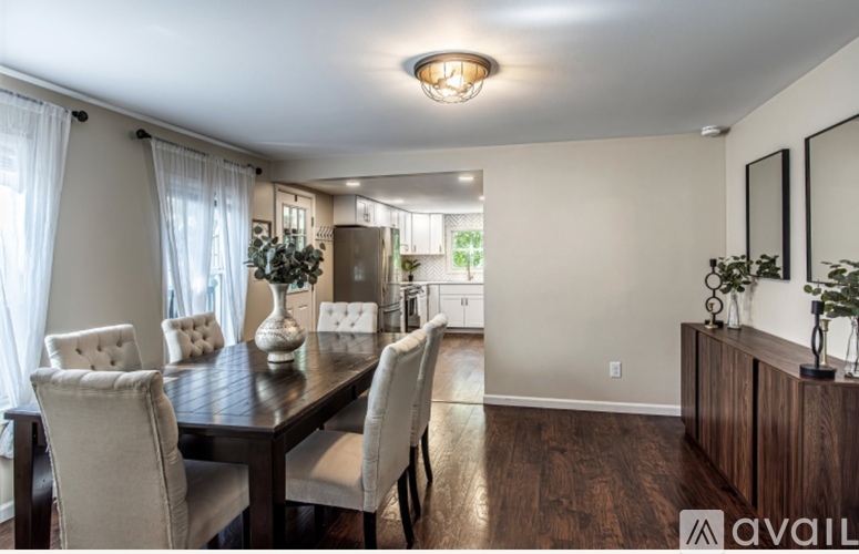 A dining room with a table and chairs.