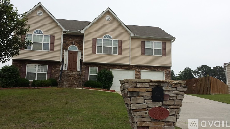 A house with a stone pillar in front of it.
