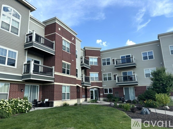 Apartment complex with balconies and green lawns.