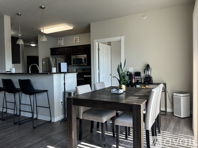 A modern kitchen with a dining table and chairs.