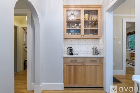 A kitchen with wooden cabinets and a white tiled backsplash.