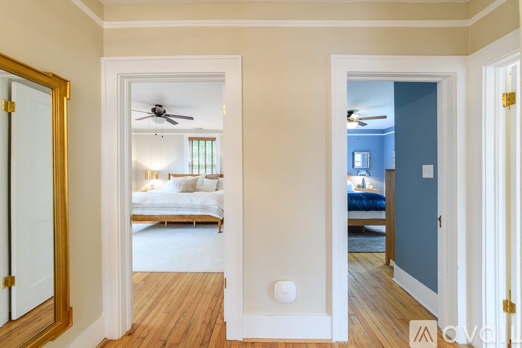 A bedroom with a bed and a ceiling fan.
