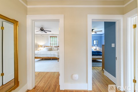 A bedroom with a bed and a ceiling fan.
