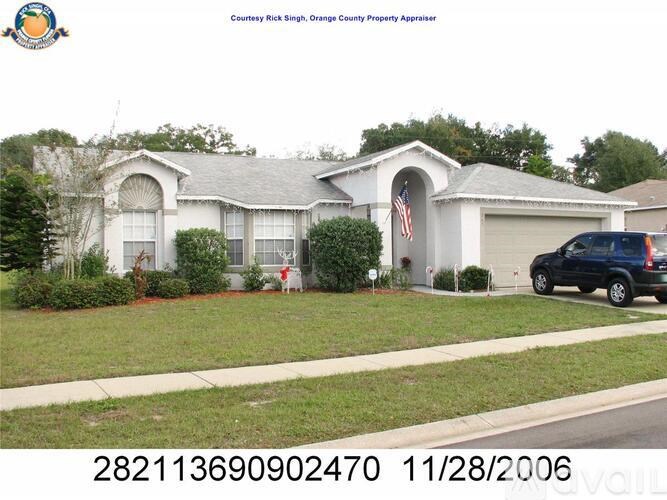 A house with a white garage door and a black truck parked in front.