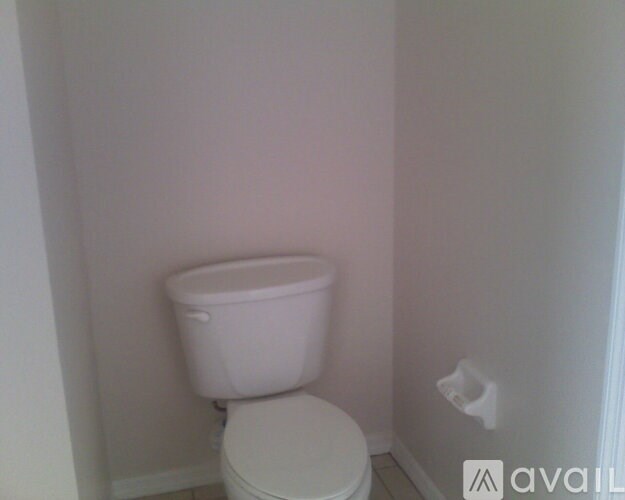 A white toilet in a small bathroom.