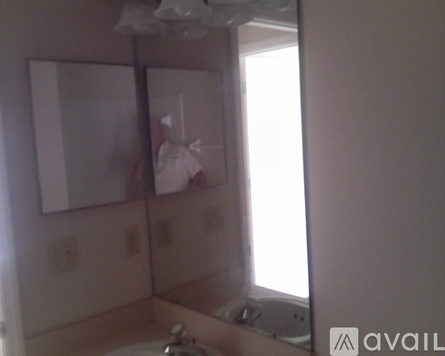 A bathroom with a sink and a mirror.