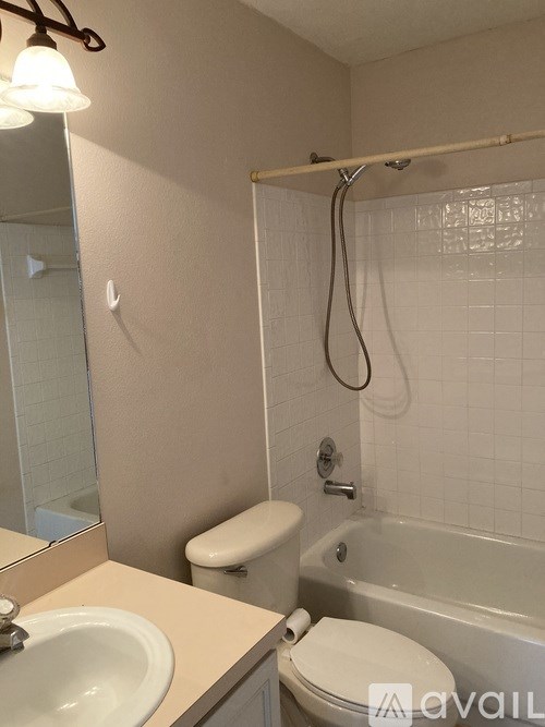A bathroom with a toilet, sink, and bathtub.