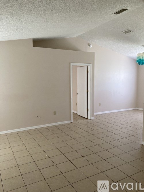 A room with a door and tiled floor.