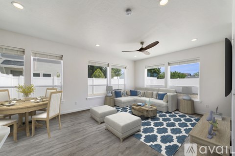 A well-lit living room with a dining table and a couch.