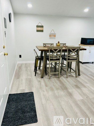 A dining room with a wooden table and chairs.