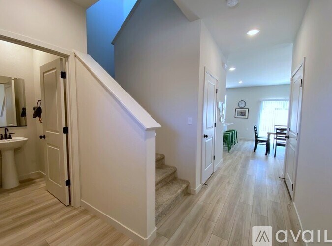 A hallway with a staircase leading to the second floor.