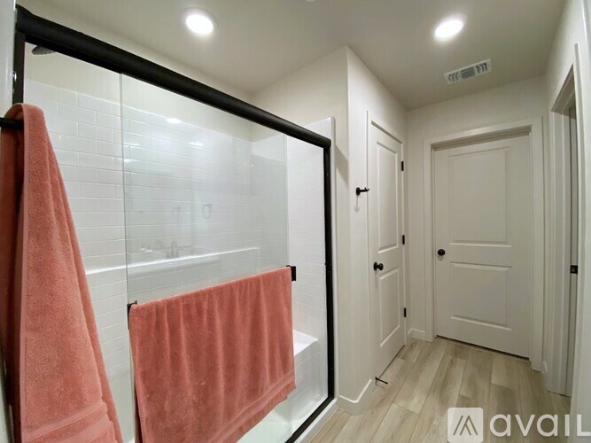 A bathroom with a towel hanging on the railing.