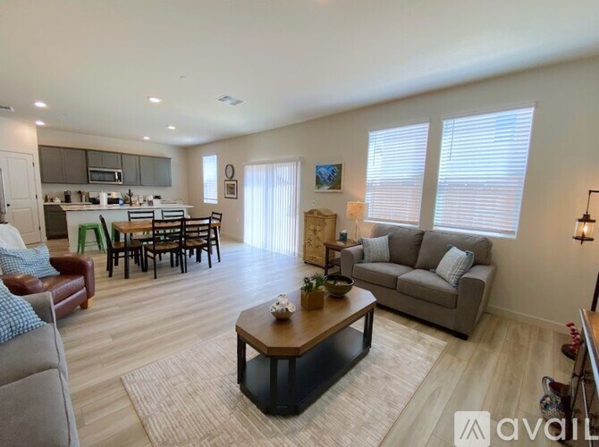 A living room with a brown leather couch and a wooden coffee table.