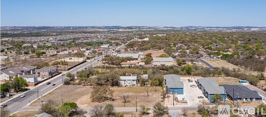 A large open area with a few buildings and a road.