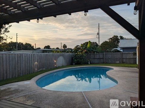 A pool under a covered patio area.