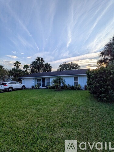 A house with a car parked in front of it.