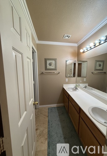 A bathroom with a tub, sink, and mirror.