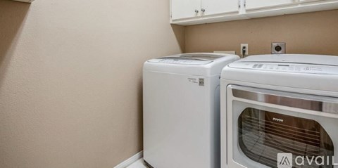 A white dishwasher and oven in a kitchen.