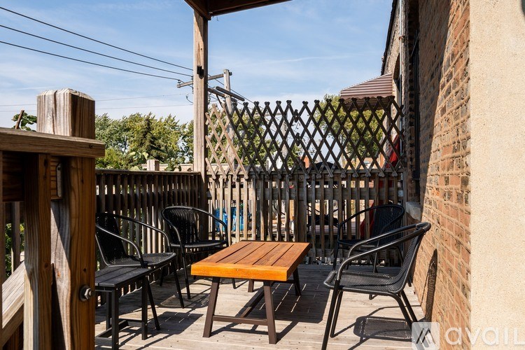 A wooden table and chairs are set up on a patio.
