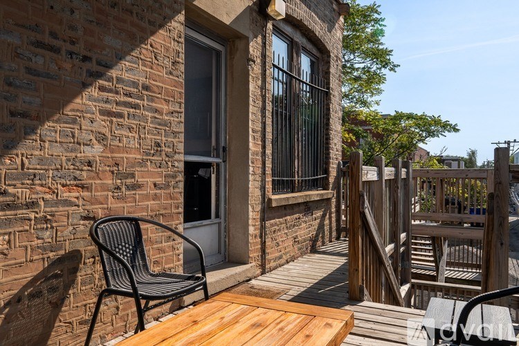 A balcony with a chair and table is shown.