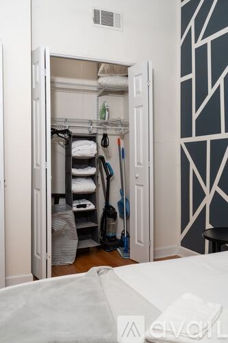 A white closet with a white bed in front of it.