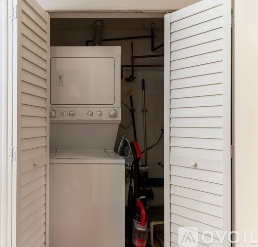 A white oven is installed in a cabinet.