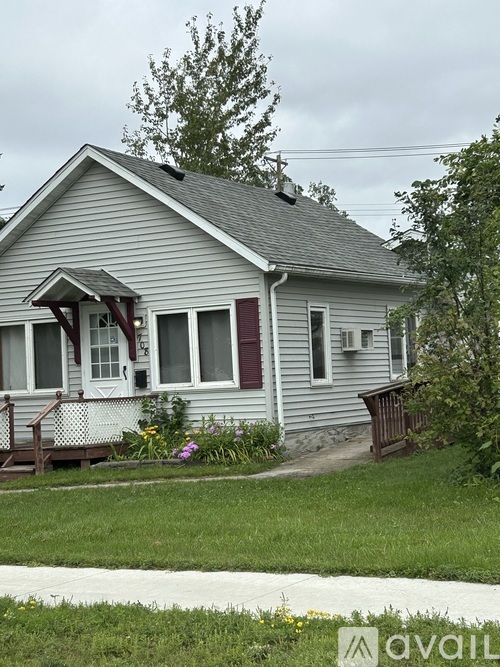 A house with a porch and a red door.