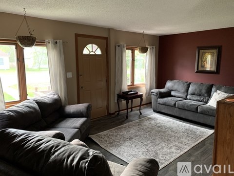 A living room with a grey couch and a small table.