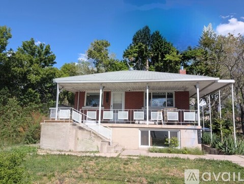 A house with a porch and a covered patio is for sale.