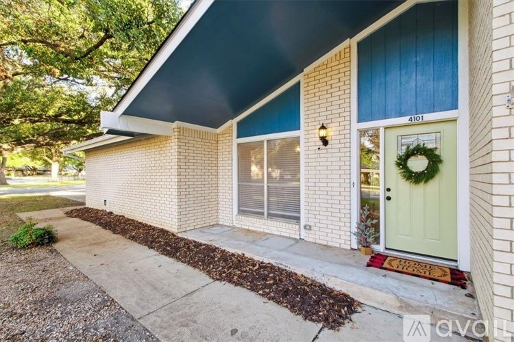 A house with a green door and a wreath on it.