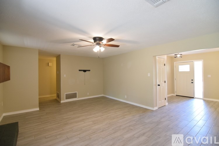 A kitchen with green cabinets and a stainless steel range hood.