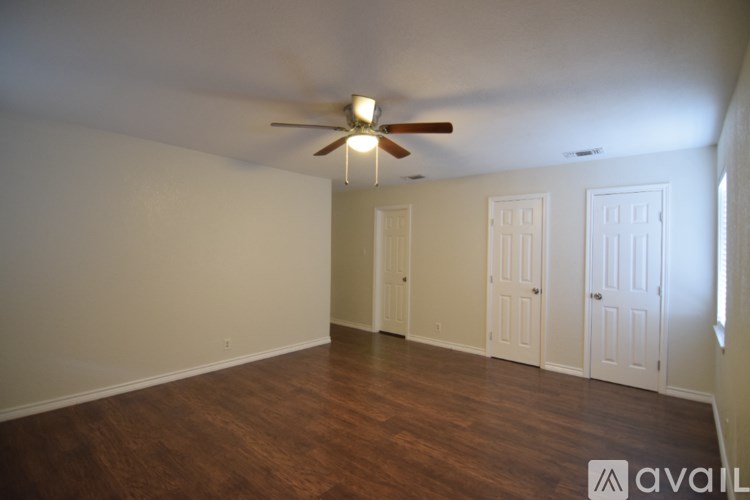 A kitchen with green cabinets and a wooden floor.