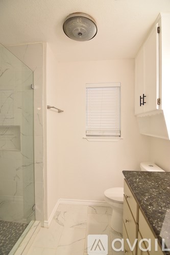 A kitchen with dark blue cabinets and a white door.