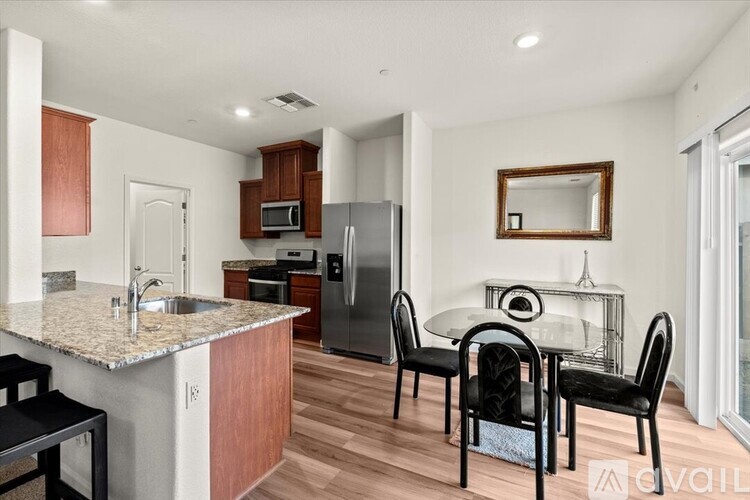 A kitchen with a table and chairs.