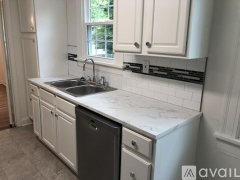 A kitchen with a sink and a dishwasher.