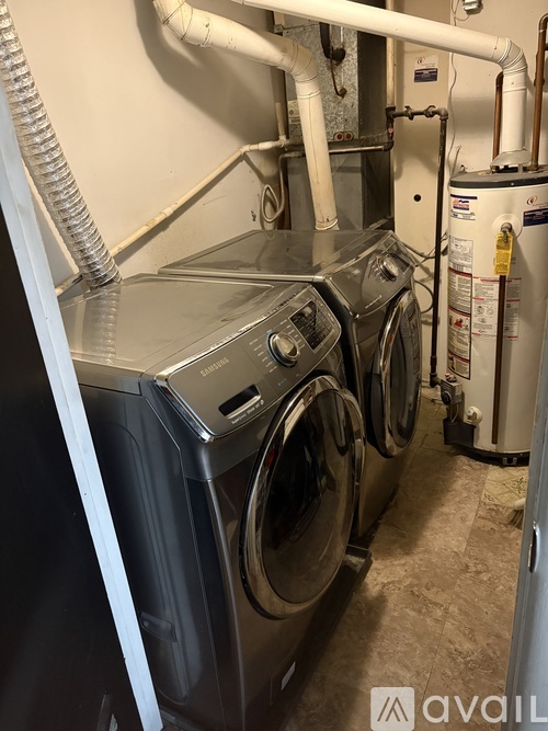 A washing machine is in the room.