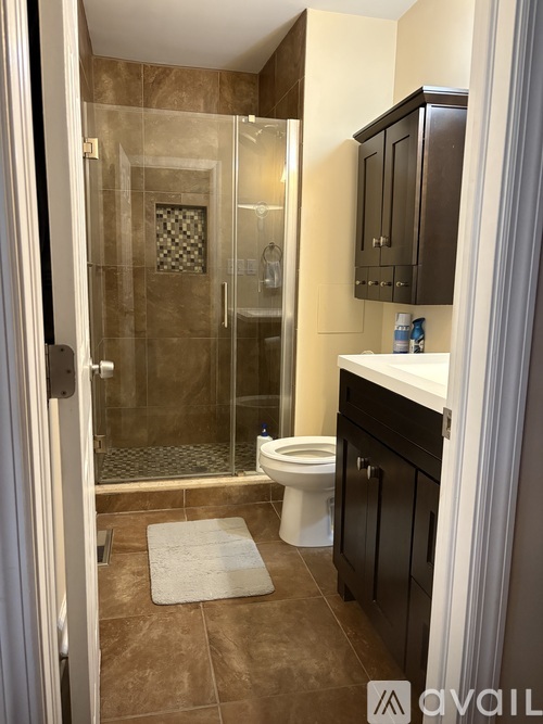 A bathroom with a toilet, sink, and shower.