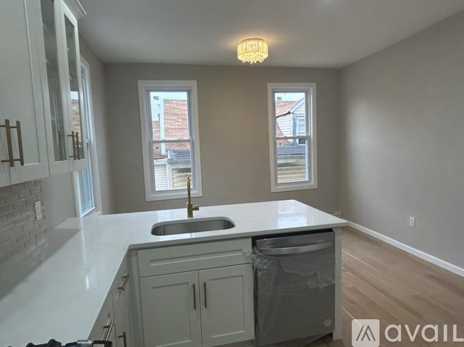 A kitchen with a sink and a window.