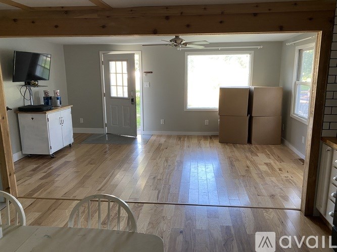 A room with wooden floors and a ceiling fan.
