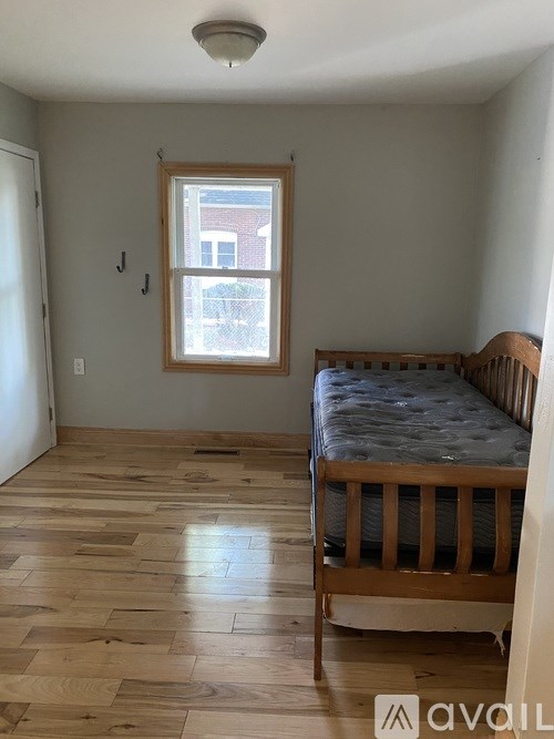 A bedroom with a bed and a window.