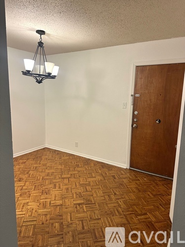 A room with a wooden floor and a wooden door.