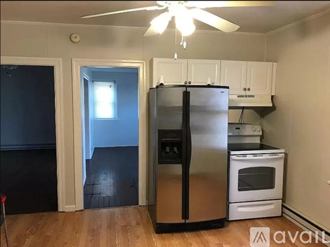 A kitchen with a stainless steel refrigerator and a white oven.