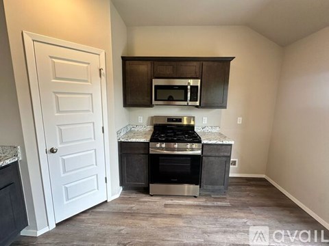 A kitchen with a stove top oven and microwave.