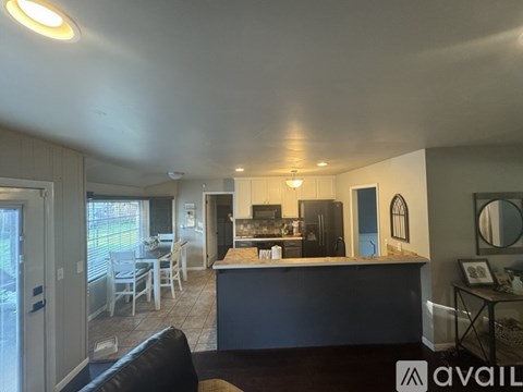 A kitchen with a refrigerator, oven, and sink.