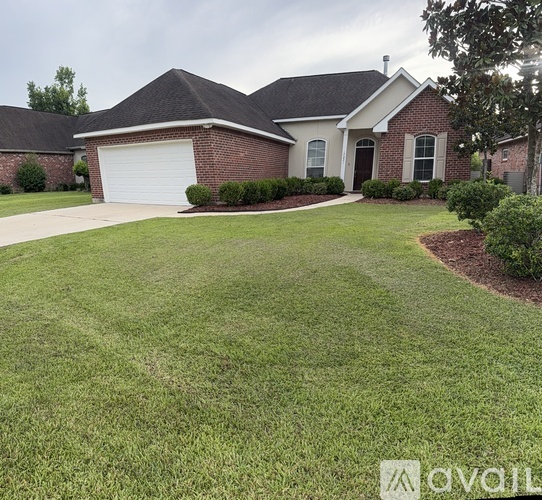 A house with a white garage door and a brick facade.
