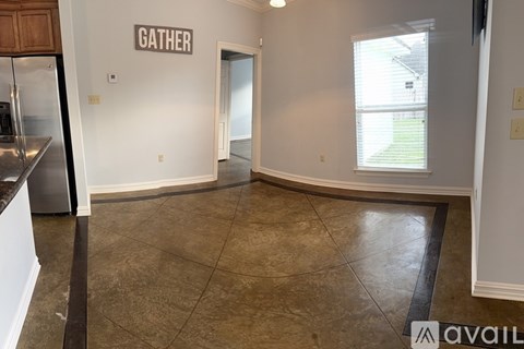 A kitchen area with a refrigerator and a countertop.